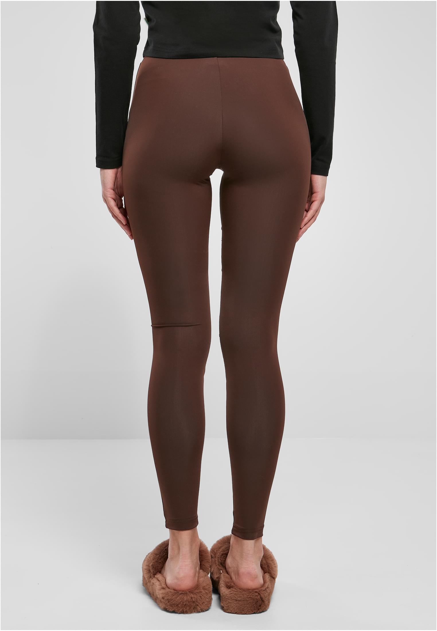 Baksidan av en kvinna som bär Ladies Tech Mesh Leggings i färgen warmgrey.