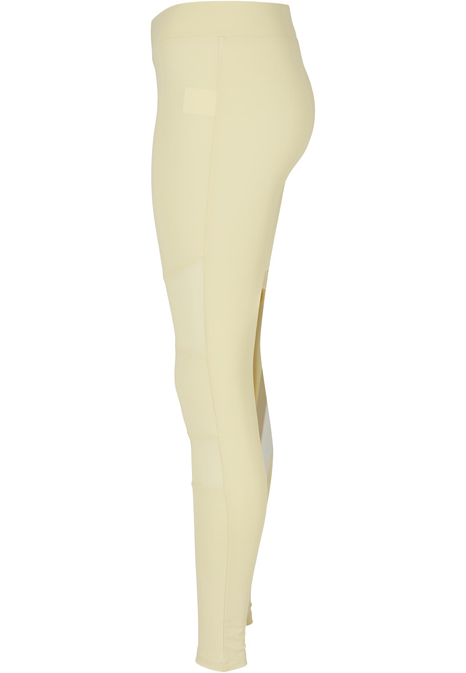 UC Ladies Tech Mesh Leggings i varmgrått, sedda från sidan för att visa mesh-detaljerna.