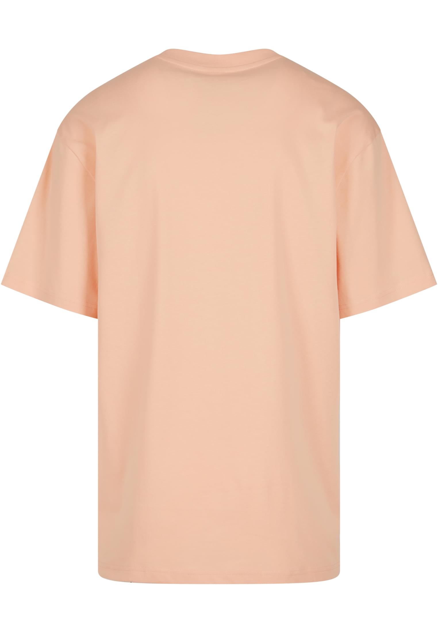 Baksidan av en ljust persikofärgad Tall Tee.
