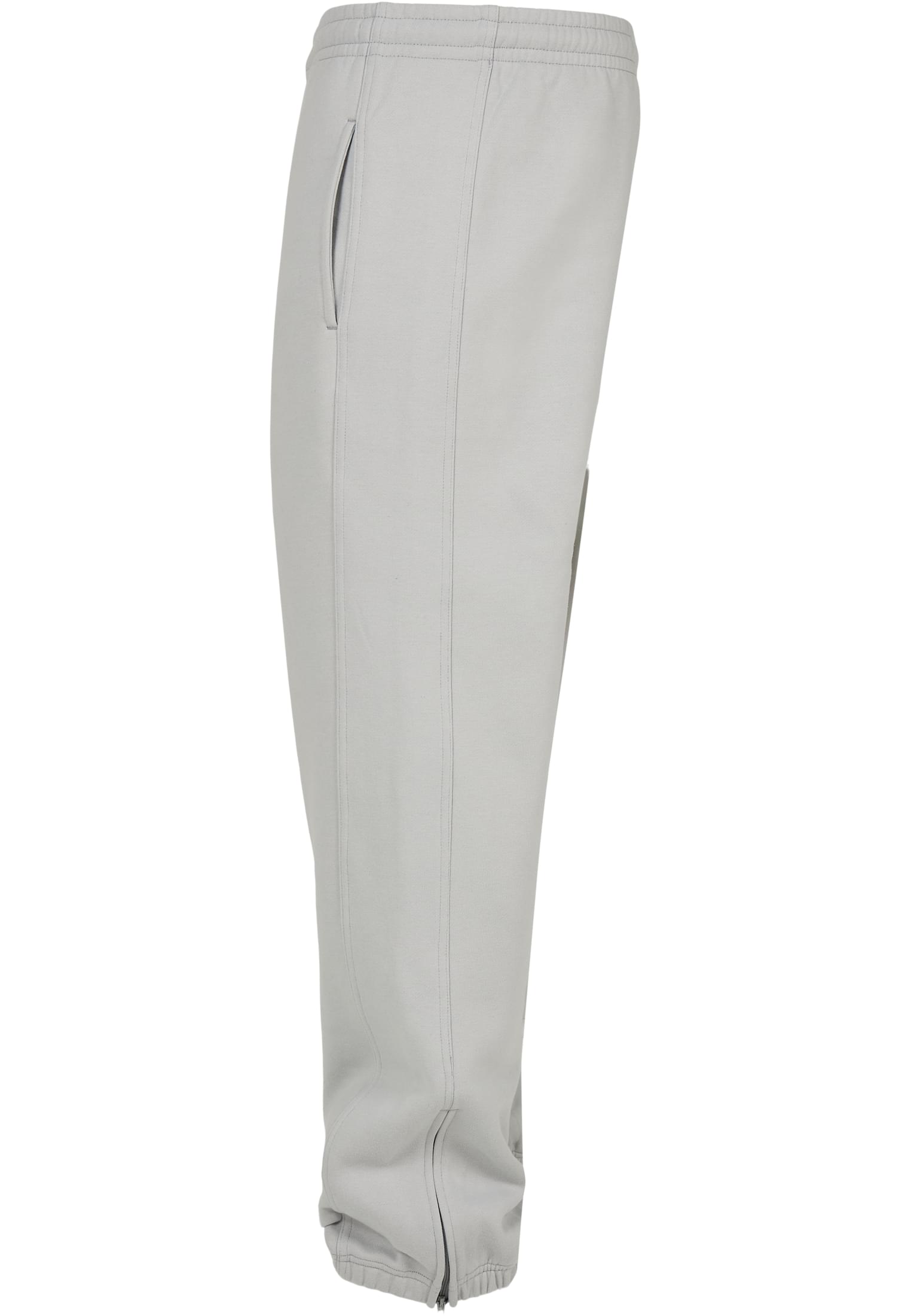 En sidovy av de ljusgrå UC Sweatpants, som visar detaljer som sidofickan, elastisk midja och dragkedja vid benslutet.