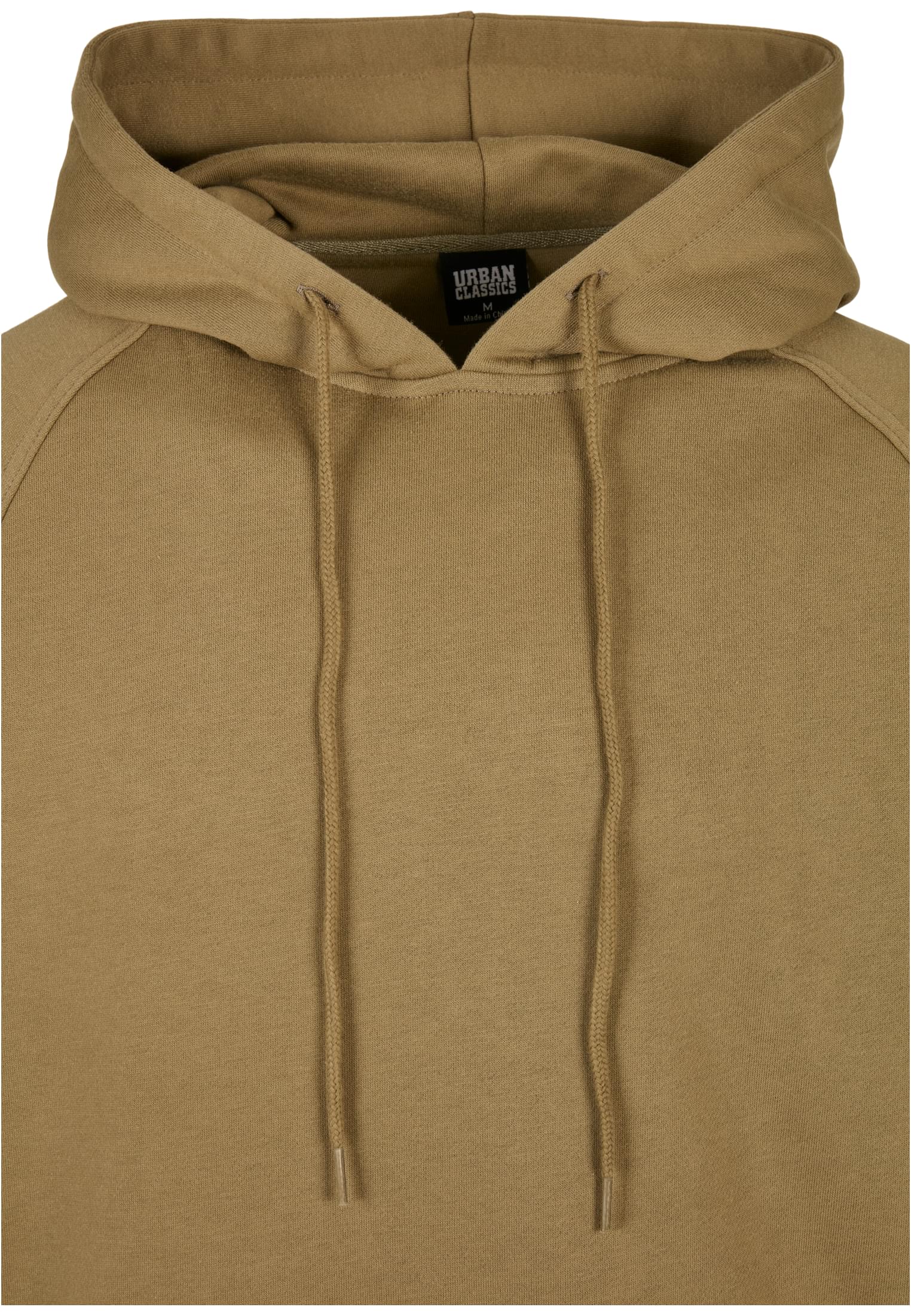 Närbild på luvan och kragen på en ljusgrön UC Blank Hoody.