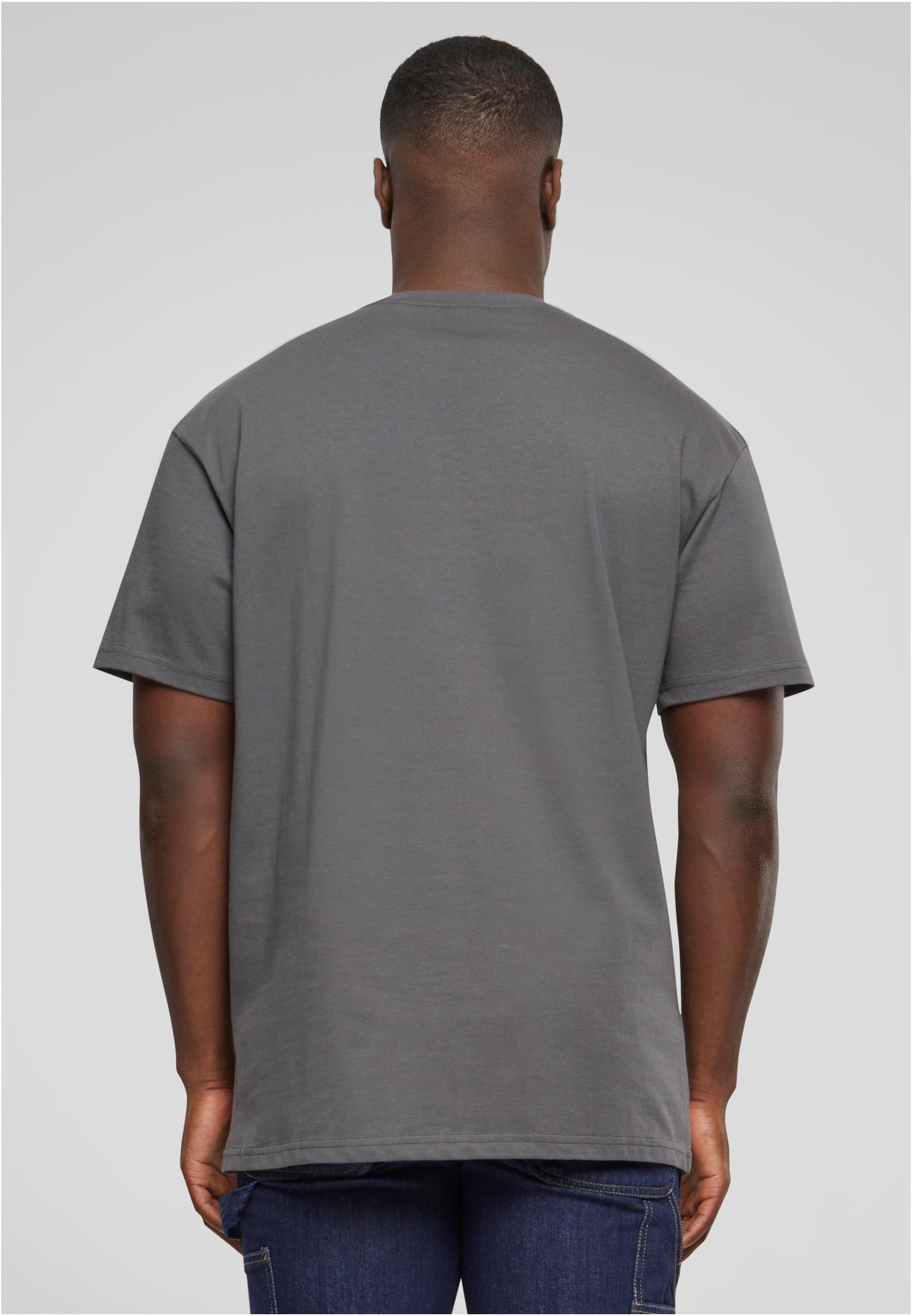 Baksidan av en manlig modell som bär en grå Heavy Oversized Tee.