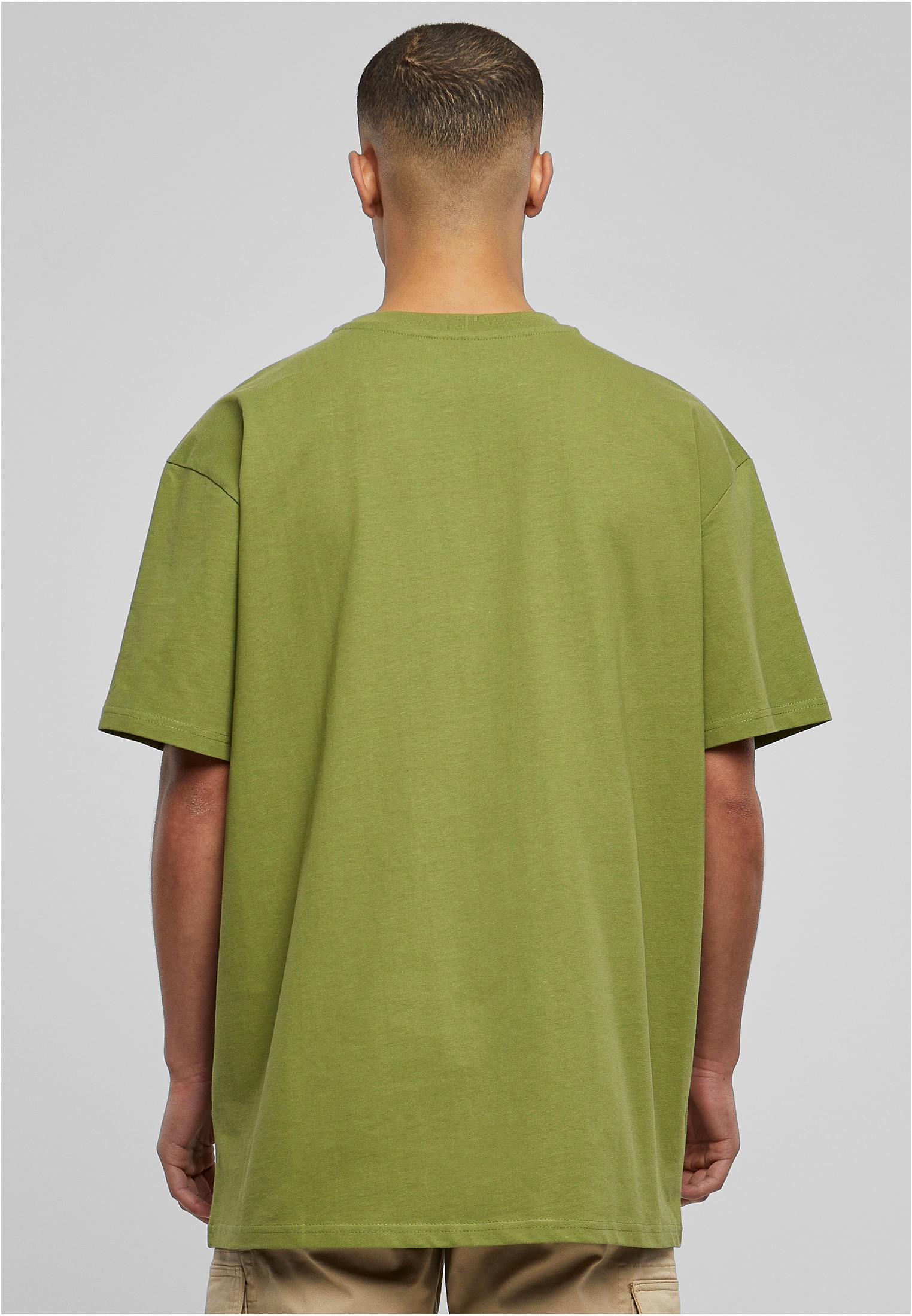 Baksidan av en man som bär en grön Heavy Oversized Tee.
