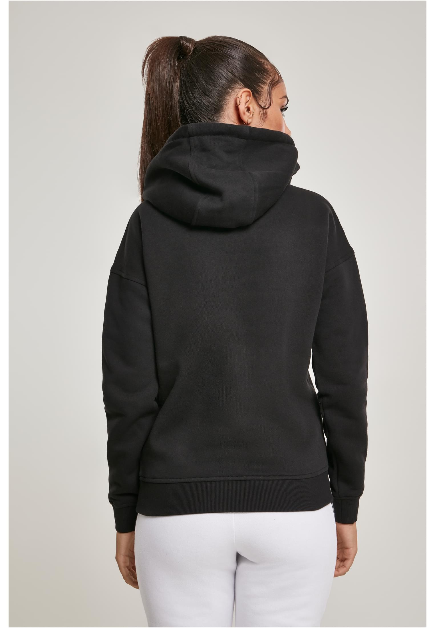 Baksidan av en kvinna som bär en svart UC Ladies Organic Hoody.