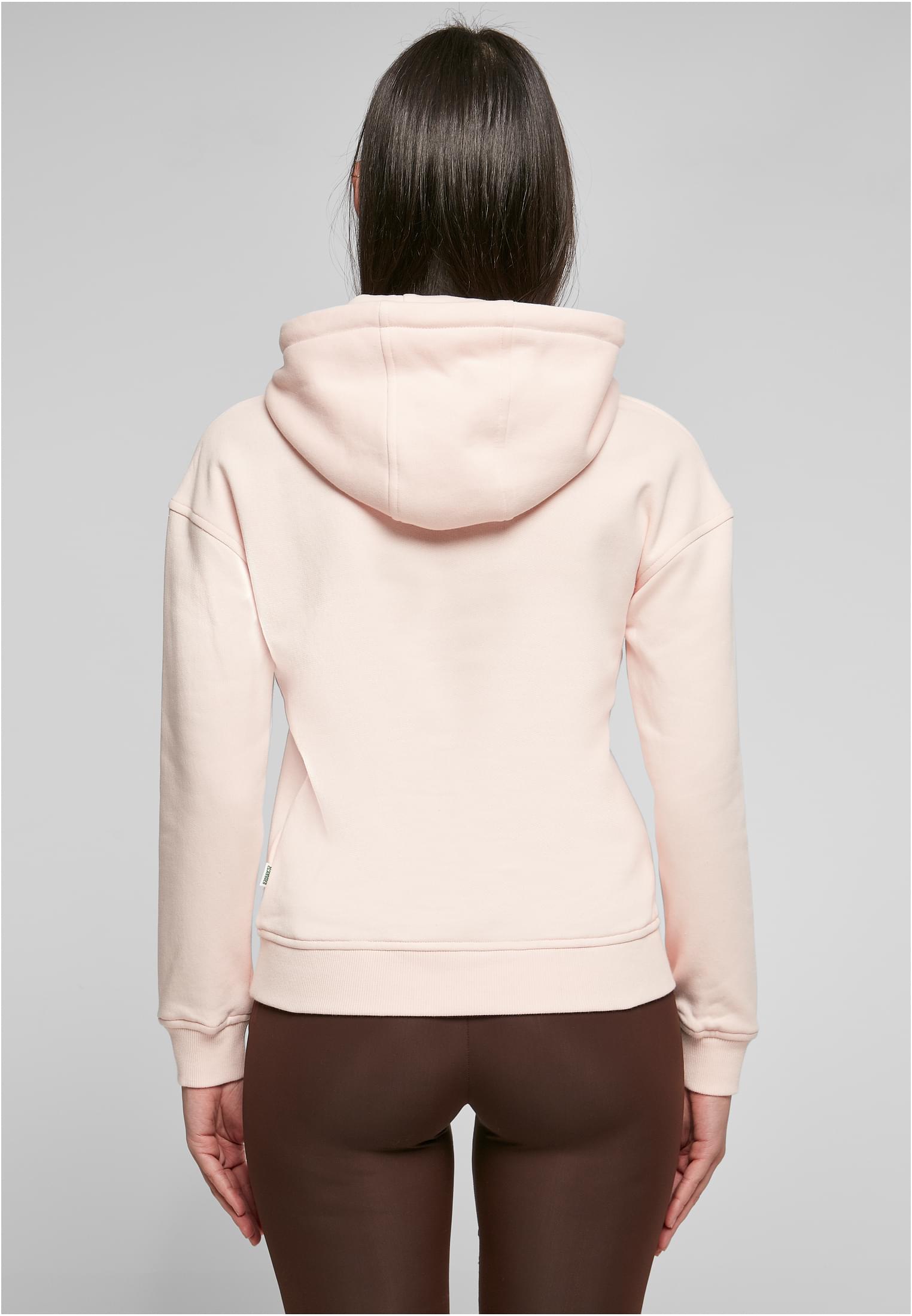 Kvinna sedd bakifrån i en terrakottafärgad UC Ladies Organic Hoody.