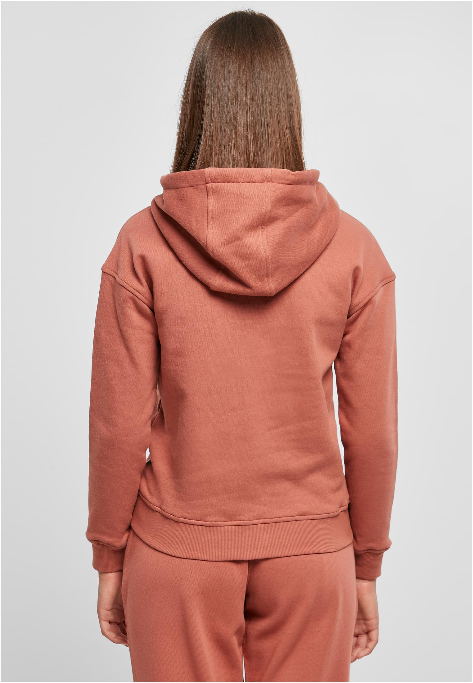 En kvinna sedd bakifrån som bär en gammelrosa UC Ladies Organic Hoody.