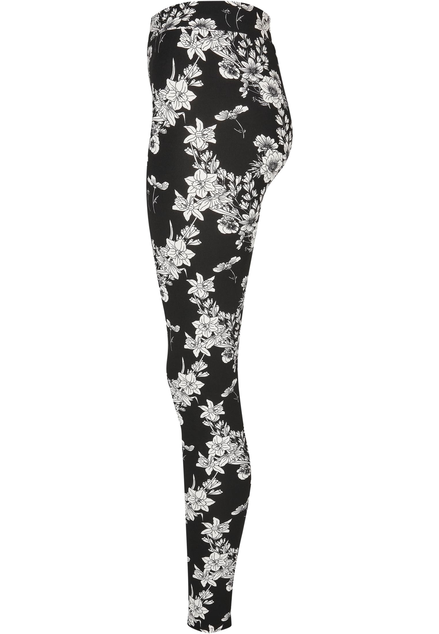 Sidovy av ett par svarta leggings med ett heltäckande vitt blommönster.
