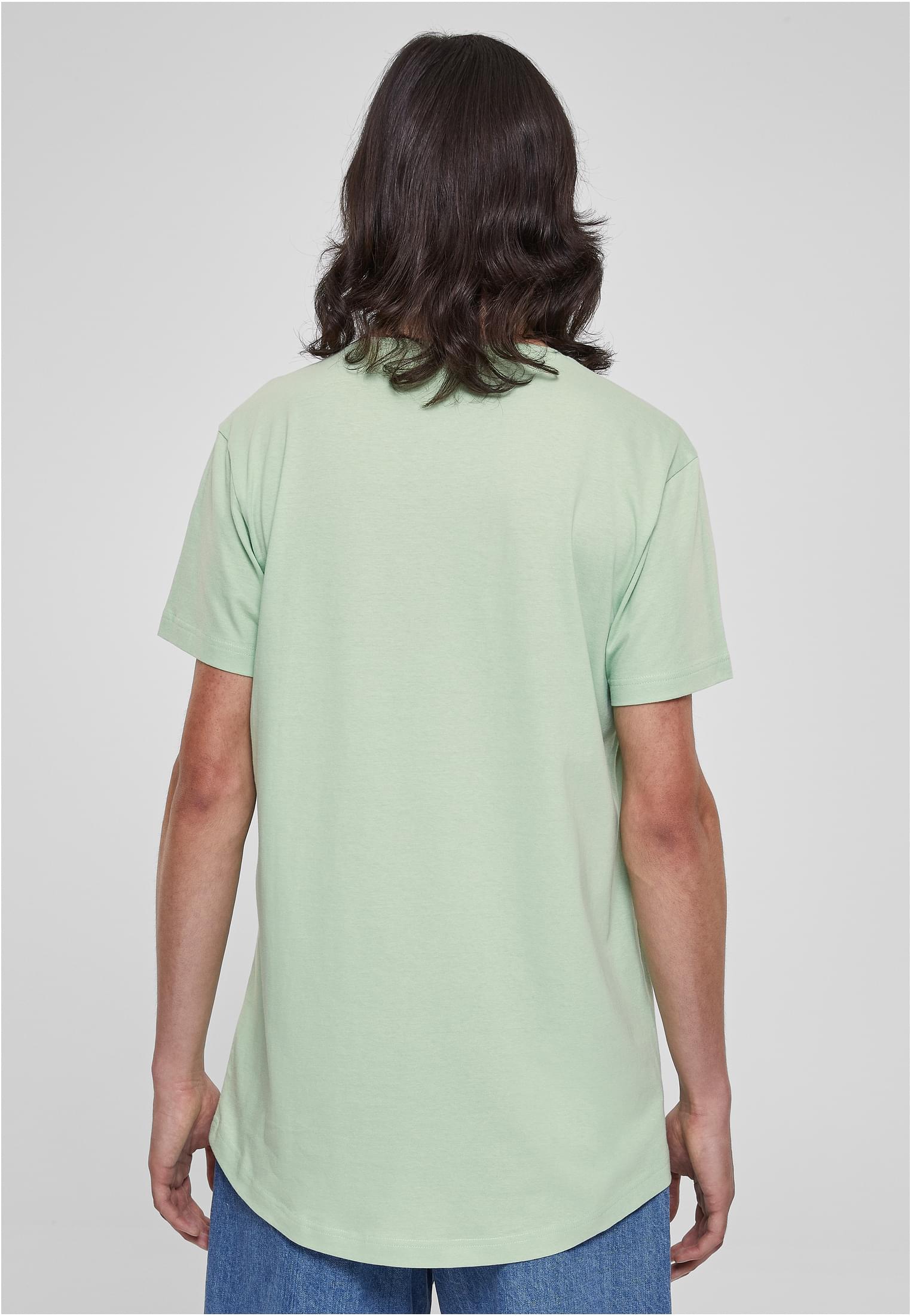 Baksidan av en man som bär en ljusgrön UC Shaped Long Tee med rundad fåll.